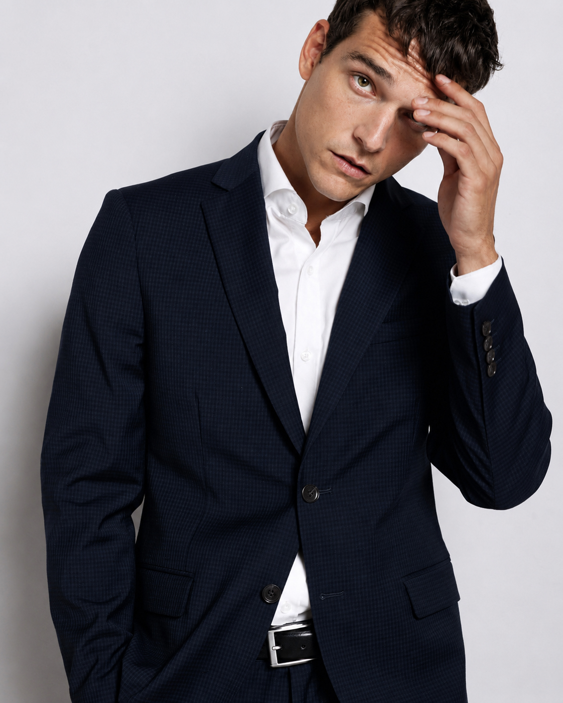 Alex wearing a navy suit and white shirt